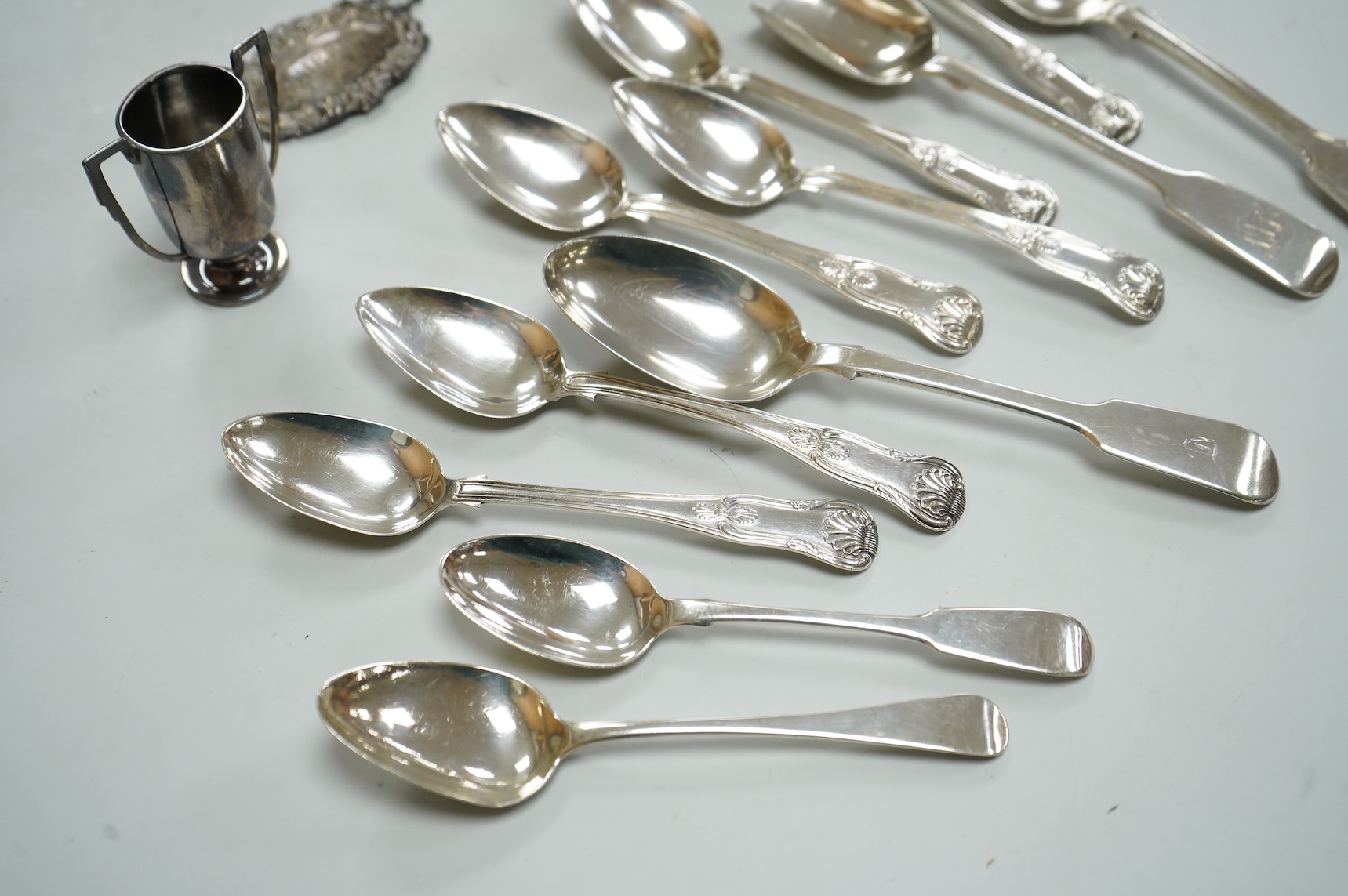 A collection of silver to include a set of six George IV silver Kings pattern teaspoons, by William Eaton, London 1824/5, five other items of silver flatware, a small trophy cup, christening mug and wine label, 13oz.